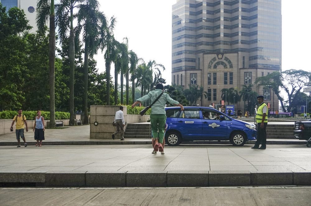 Chinese tourist pose at Petronas Twin Tower