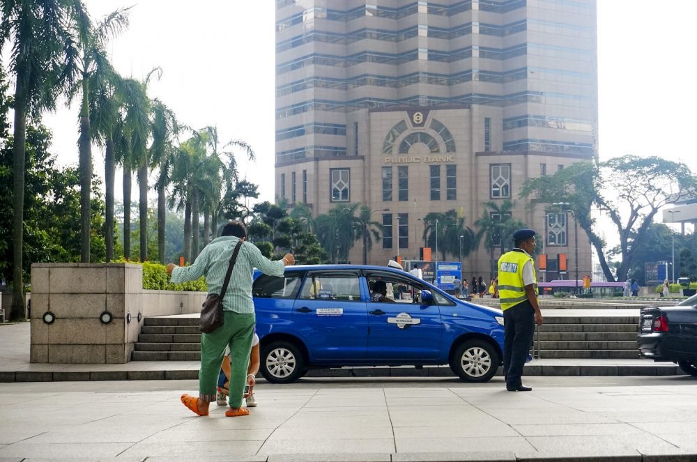 Chinese tourist pose atPetronas Twin Tower