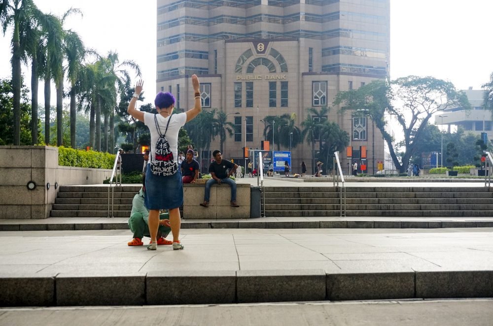 Chinese tourist pose at Petronas Twin Tower