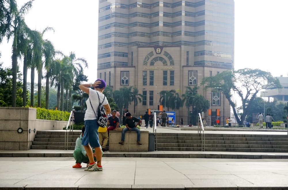 Chinese tourist pose at Petronas Twin Tower